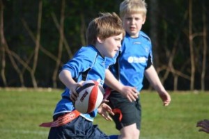 Boys playing tag rugby
